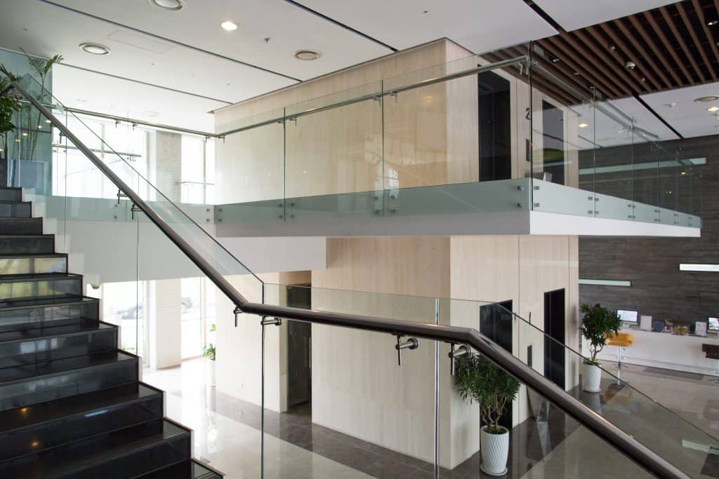 Glass railing along an upper level inside a modern building