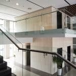 Glass railing along an upper level inside a modern building